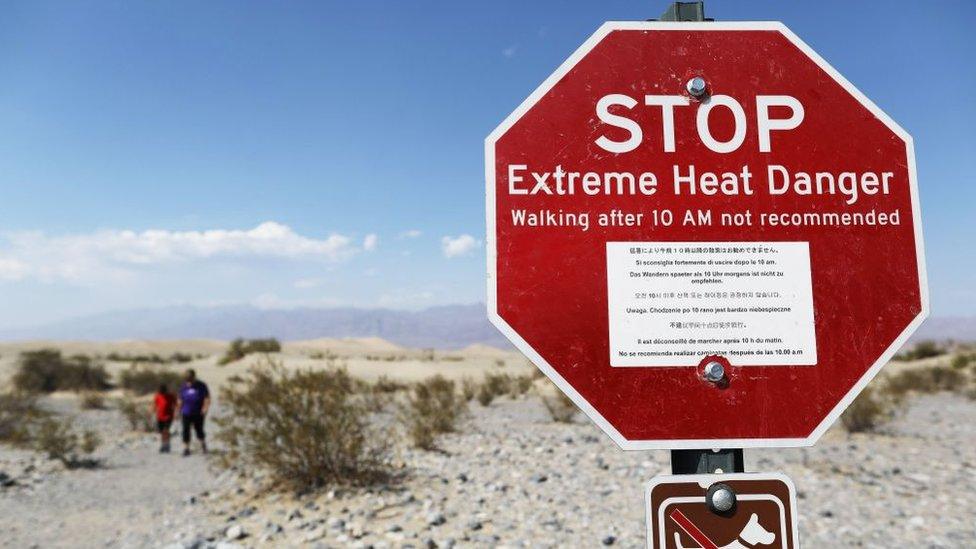 warning sign in death valley that reads extreme heat danger walking after 10 am not recommended