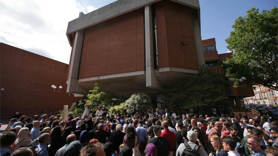 People gather outside Kensington Town Hall on Friday
