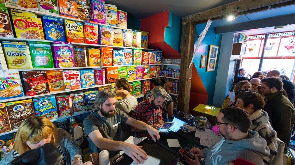 Customers queuing for a selection of cereals at a cereal cafe