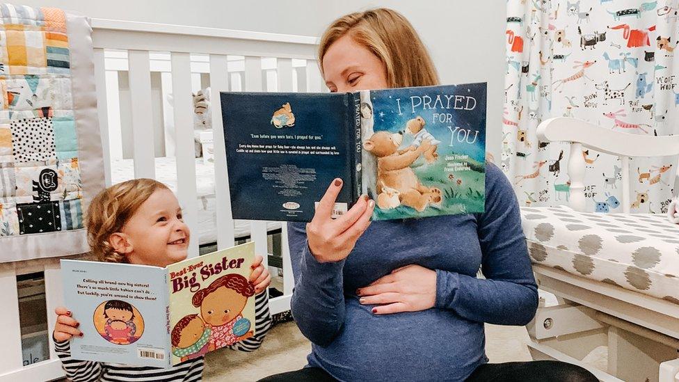 Tina Gibson reads to her daughter, Emma