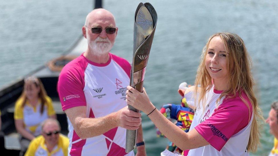 Neil Kegg and Rossana Dale holding the Queen's baton