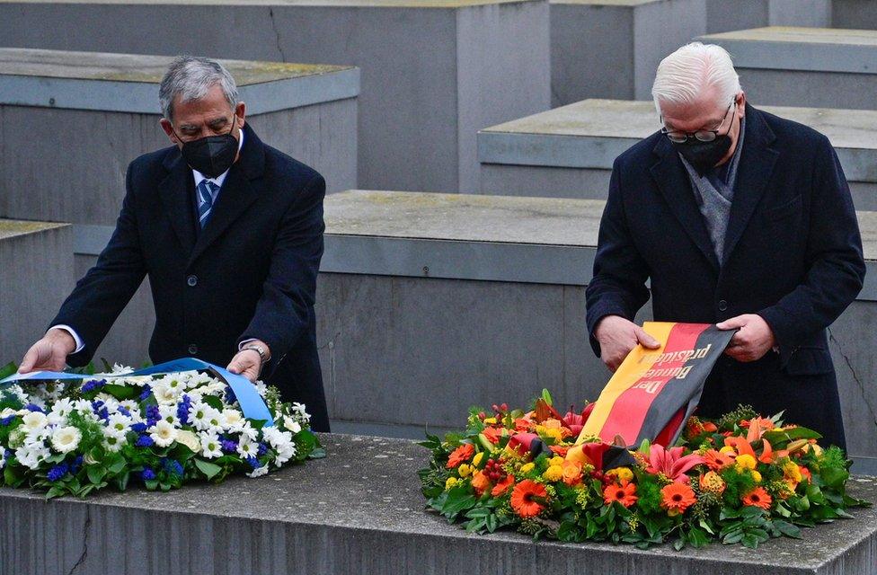 German President Frank-Walter Steinmeier and the Speaker of Israel's Knesset parliament Mickey Levy arrange wreaths at Berlin's Holocaust memorial on 27 January 2022