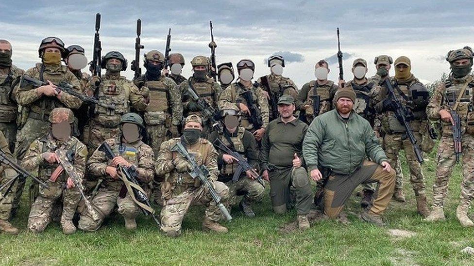Tommy Moore with Brett Mackenzie and some of the soldiers they trained