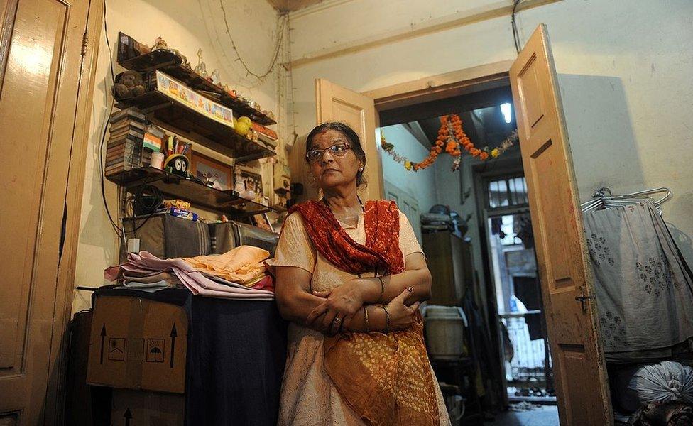 Smita Panvalkar stands inside her apartment in the Pathare Prabhu building, due to be demolished to make way for a luxury apartment building, in Mumbai on June 24, 2011.