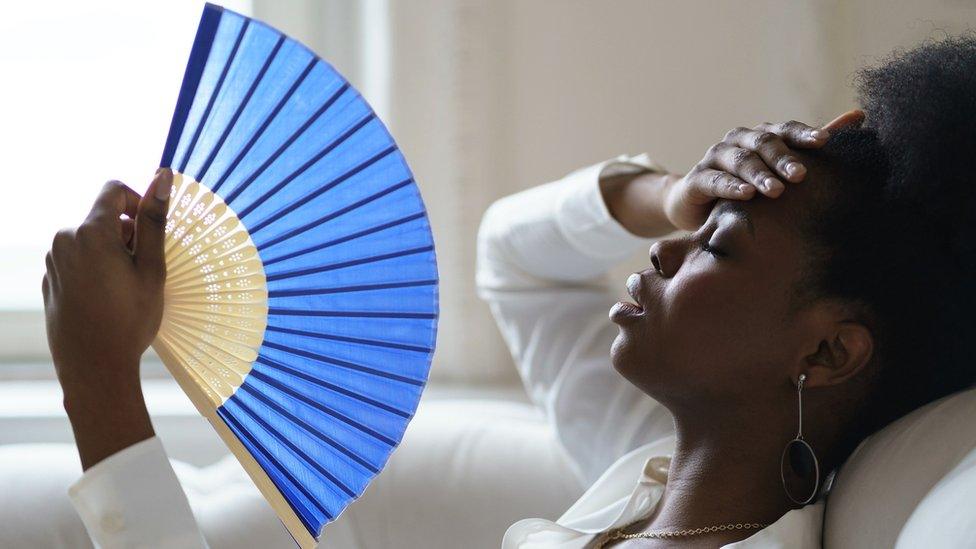 Woman holding a fan