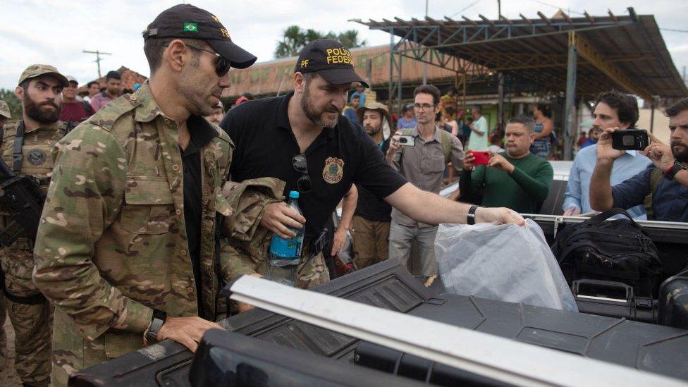 Experts from the Federal Police from the Task Force get on a pick-up truck upon arriving at the port of Atalaia do Norte. 14 June 2022