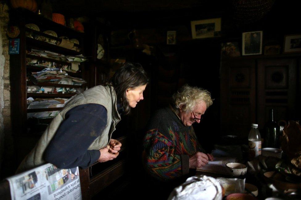 Jean-Bernard writes noted as Laurence looks on