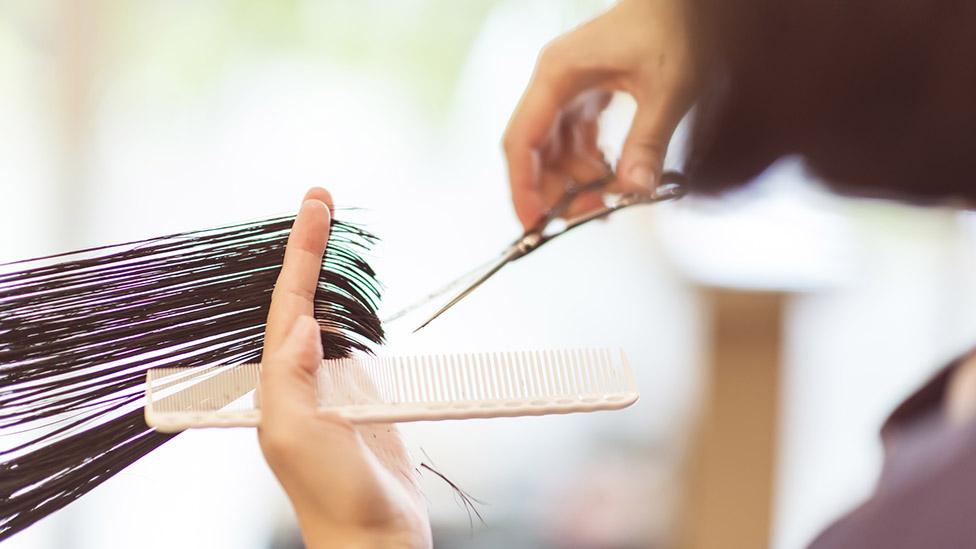 A hairdresser cutting hair (file image)