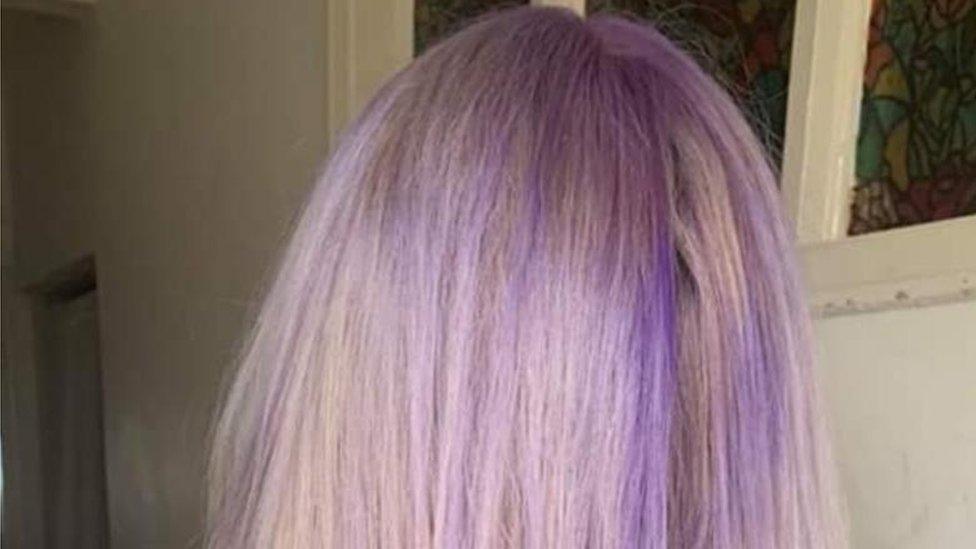 Woman with blonde hair turned purple