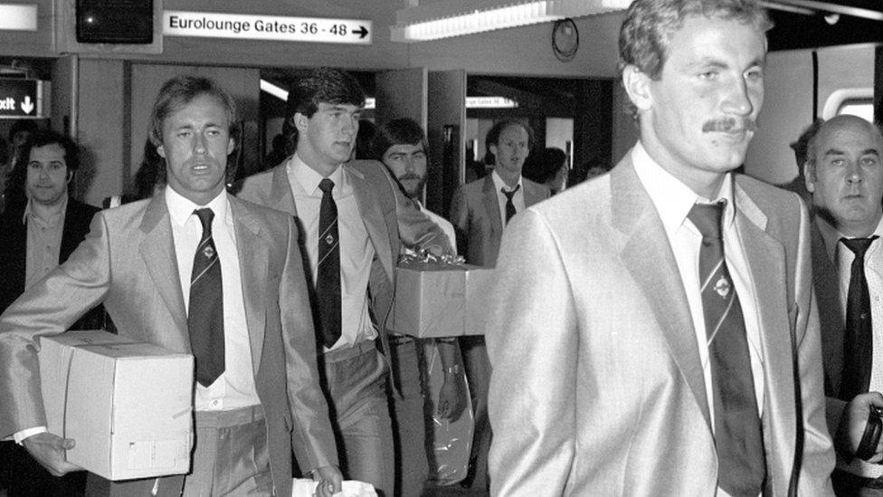 Billy Hamilton (front) with Sammy McIlroy and Norman Whiteside at Heathrow Airport following the Northern Ireland team's exit from the 1982 World Cup