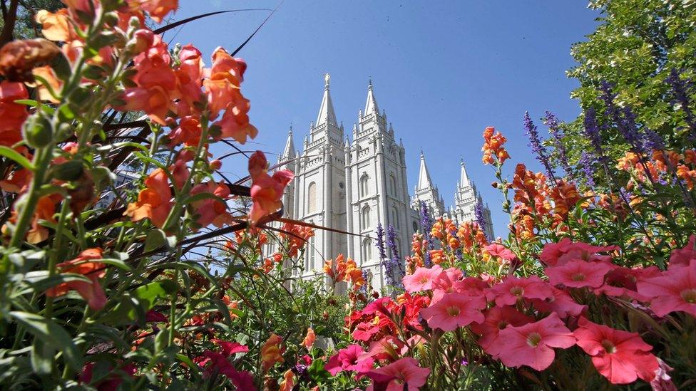 This Aug. 4, 2015,,file photo, flowers bloom in front of the Salt Lake Temple, at Temple Square, in Salt Lake City.