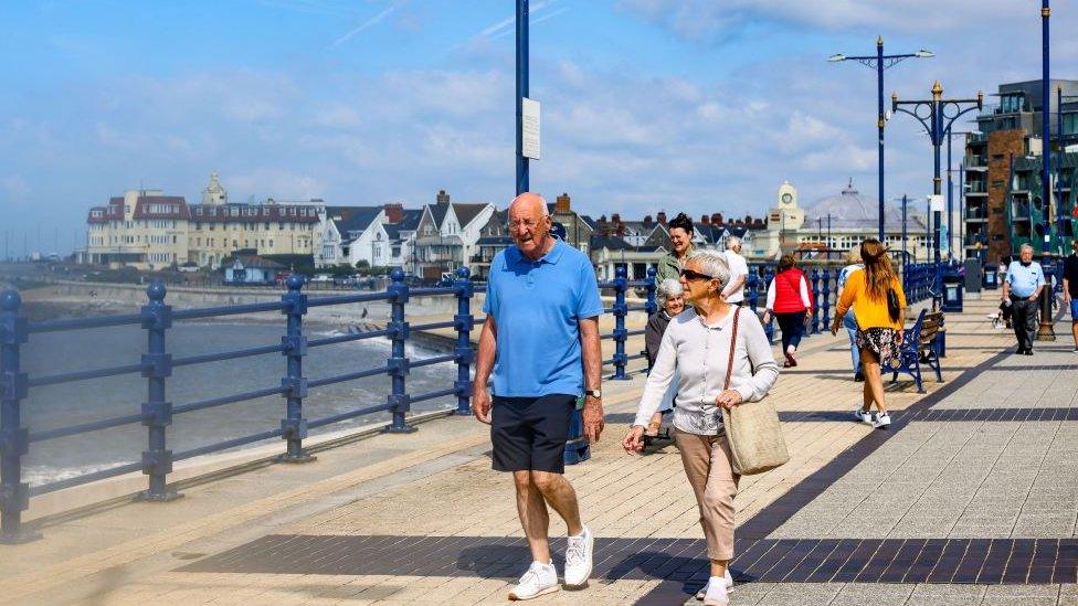 Couple walking in the sun