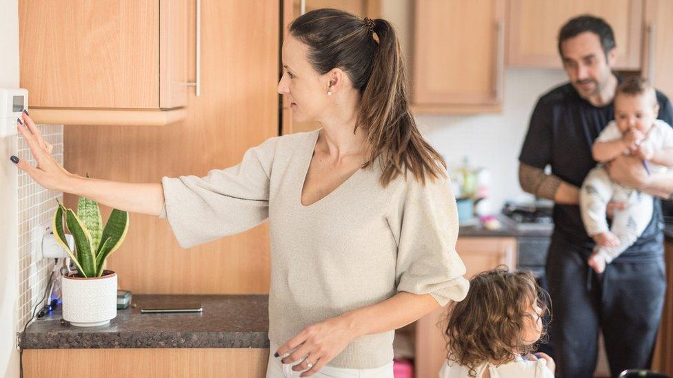 Mother adjusting heat settings