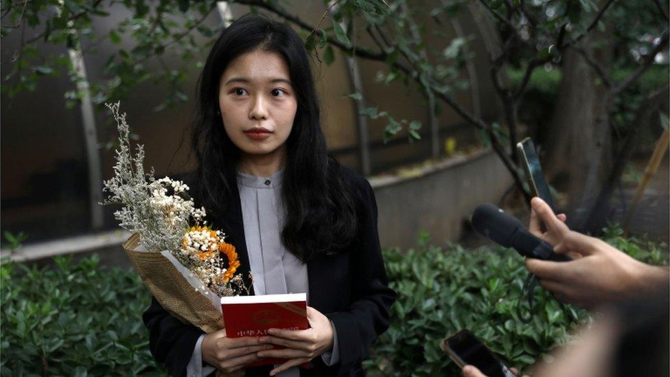 Zhou Xiaoxuan, also known by her online name Xianzi, speaks to supporters as she arrives at a court for a sexual harassment case involving a Chinese state TV host, in Beijing, China on 14 September 2021