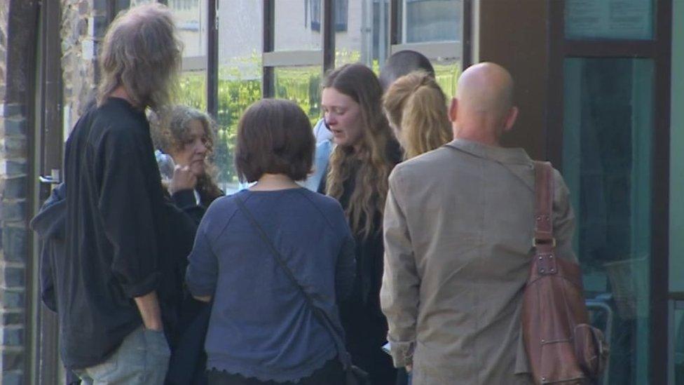 Tristan Silver's mother Cloud Younger (centre, long hair) , surrounded by people