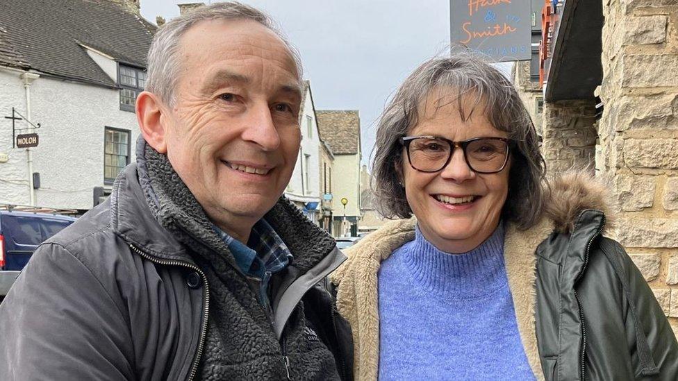 Les Przeleski, 65, and Cathy Przeleski, 66, standing in the centre of Tetbury smiling at the camera