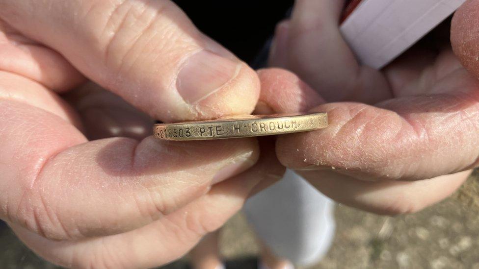 Close up of rim of the medal which displays Pte H Crouch