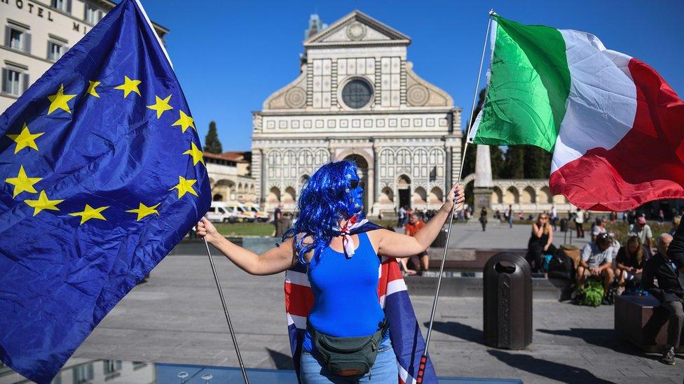 A woman protester in Florence, where Theresa May gave her speech