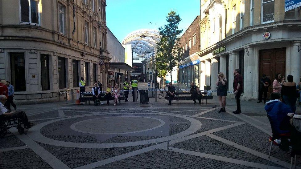 People waiting outside Friars Walk in Newport