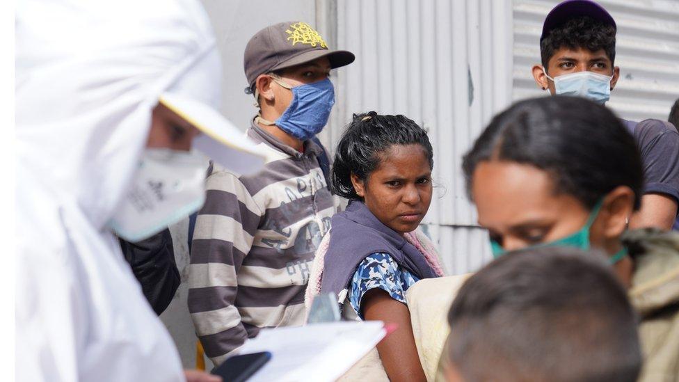 A Venezuelan migrant waits to be registered at the entrance of Pamplona on 30 September.