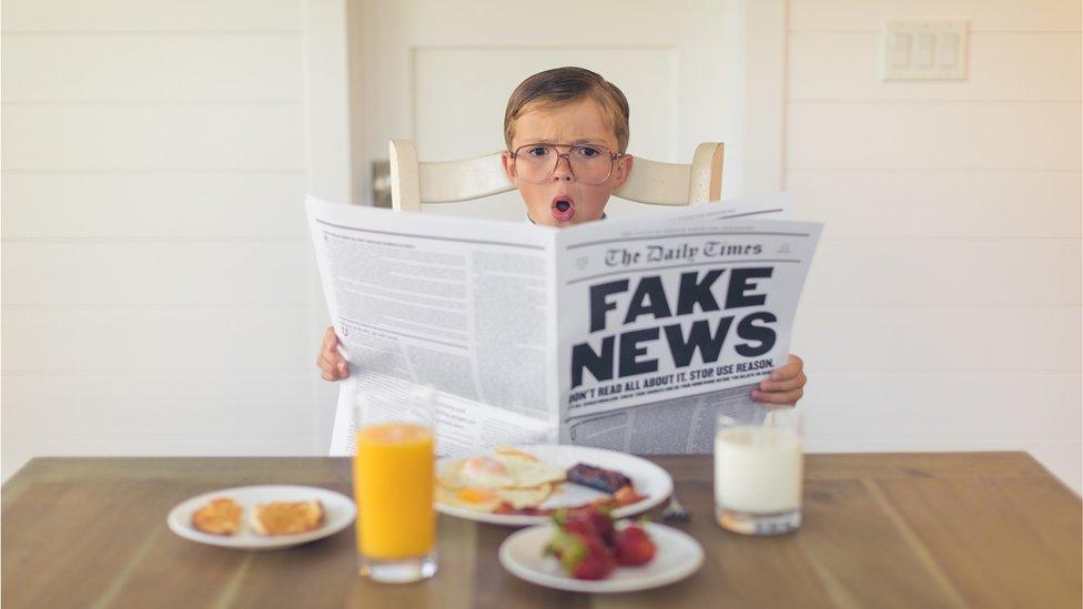 boy reading paper