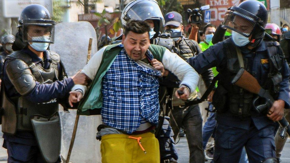 Nepalese police arrest a man during the demonstration