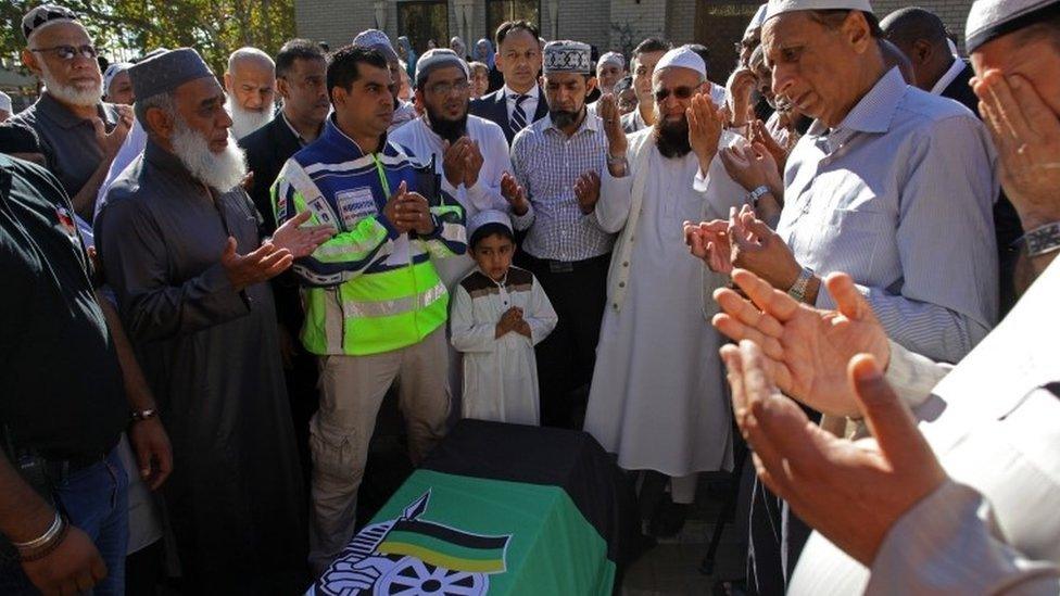 Mourners pray next to the coffin of anti-apartheid activist Ahmed Kathrada, as they leave from a family members home in Houghton, ahead of the funeral, in Johannesburg, South Africa, 29 March 2017