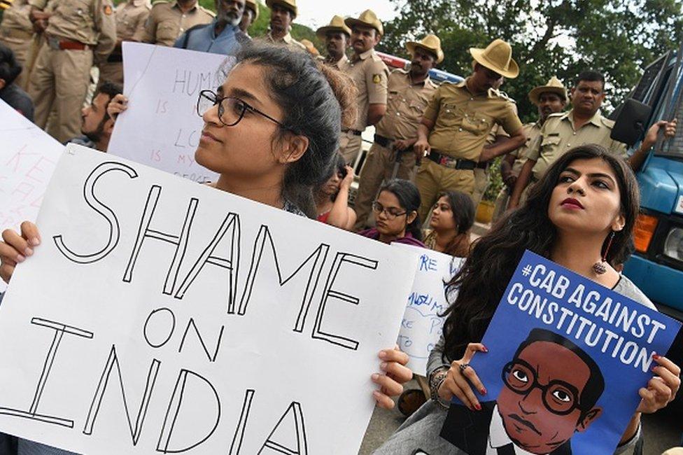 Students and activists hold placards and shout slogans during a protest against the Indian government's Citizenship Amendment Bill (CAB) in in Bangalore on December 16, 2019