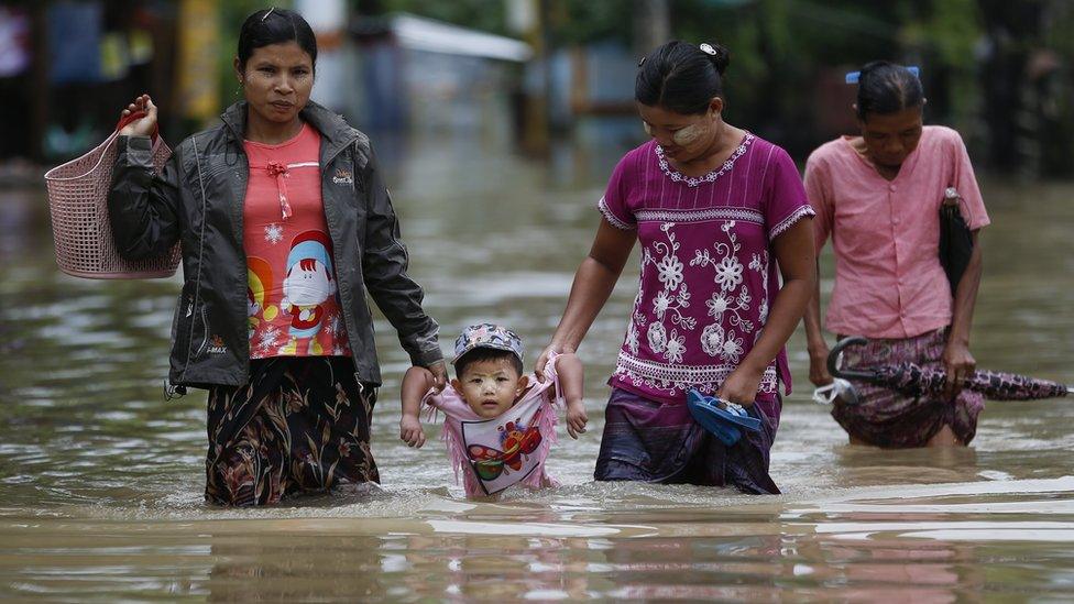 Family in a flooded street