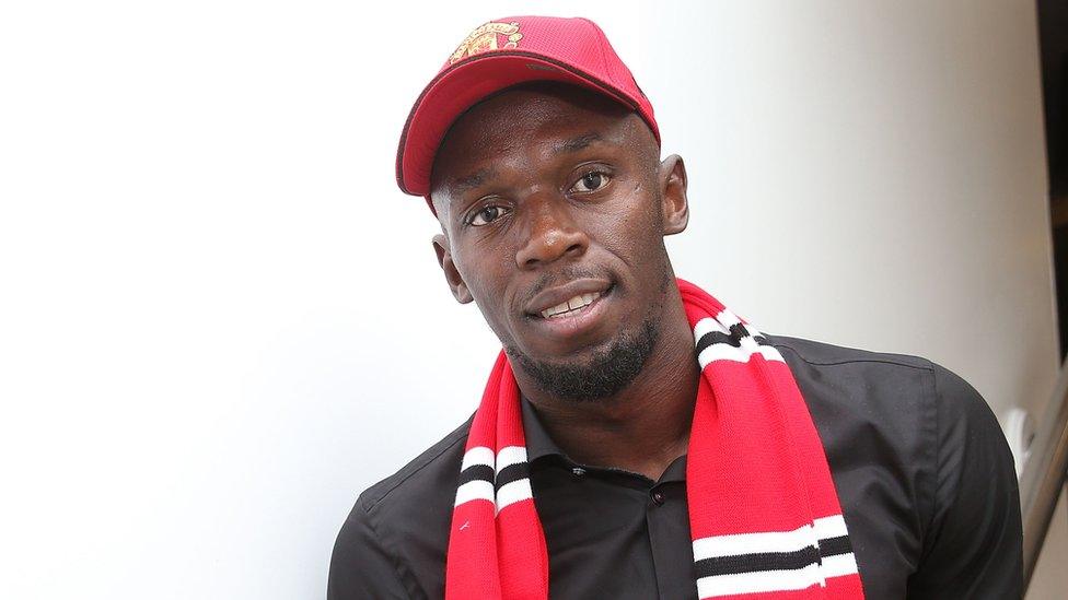 Usain Bolt in Man Utd hat and scarf