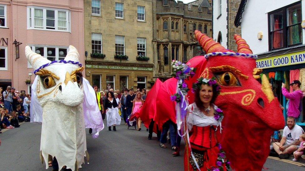 Glastonbury Dragons parading Glastonbury High Street