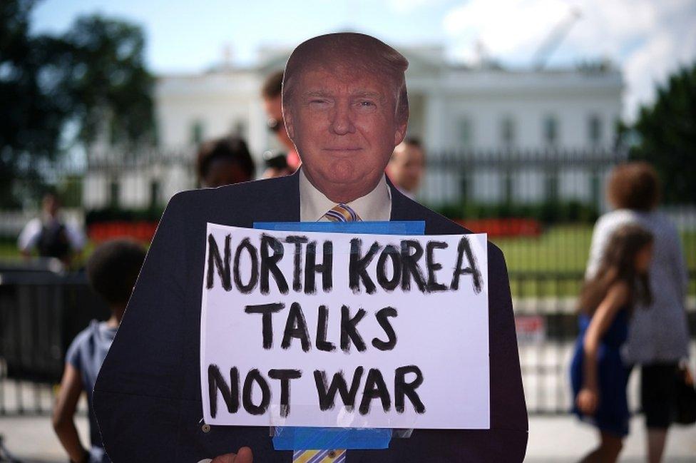 Protesters outside the White House call for a de-escalation in tensions