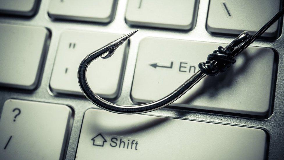 Fishing hook on a computer keyboard