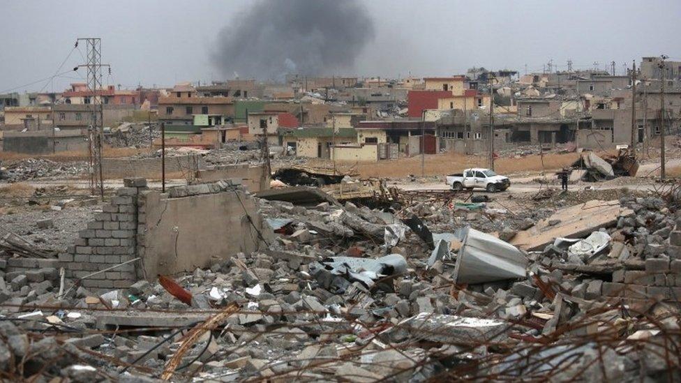 Smoke rises from multiple Katyusha rockets fired by IS militants at Kurdish Peshmerga forces occupying ruins of the town of Sinjar (16 November 2015)