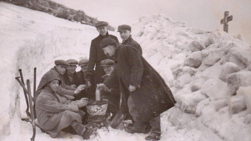 workers clearing the snow after the war