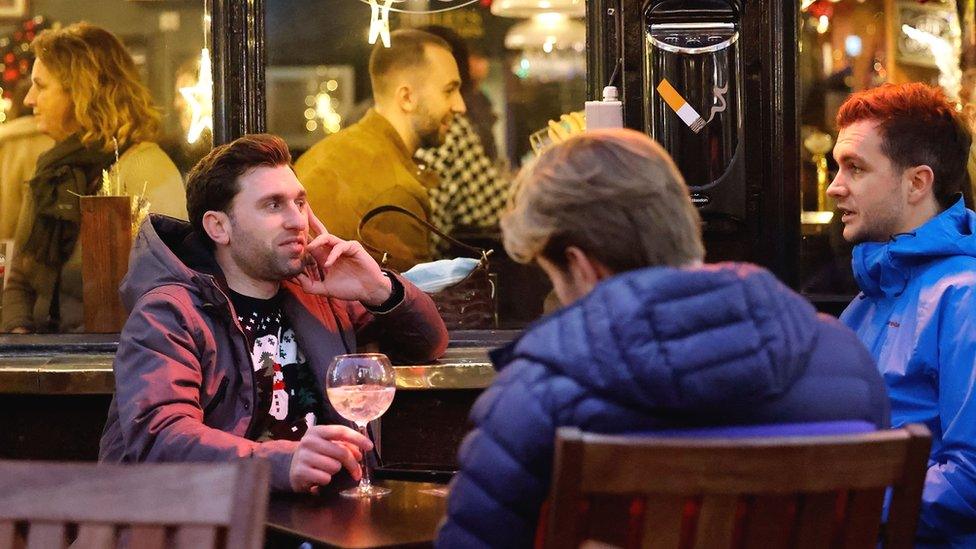 People sit outside a pub