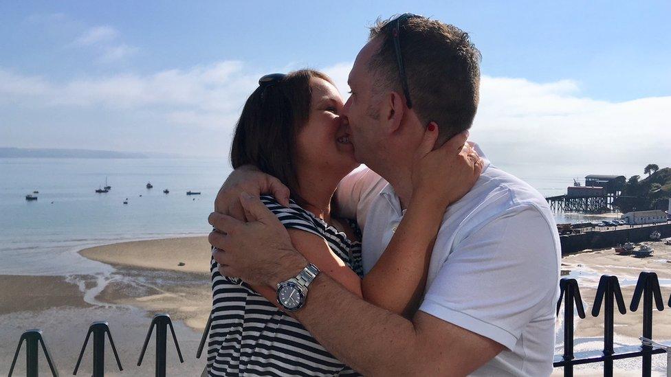 Emma Cornick and Neil Brierley kissing at Tenby beach after getting engaged