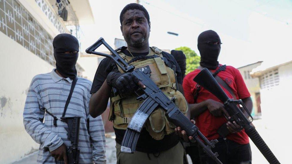 Former police officer Jimmy "Barbecue" Cherizier, leader of the 'G9' gang alliance, is flanked by gang members after a press conference in Delmas 6, Port-au-Prince, Haiti March 5, 2024.