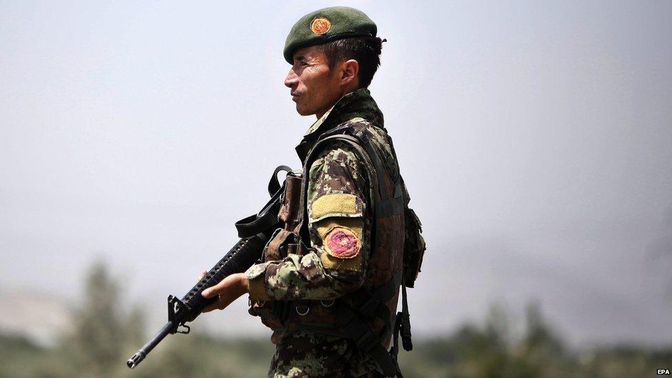 A member of the Afghan security forces stands guard on a roadside as security is increased following reports of the death of Mullah Omar, the leader of the Afghan Taliban, in Kabul, Afghanistan, 29 July 2015