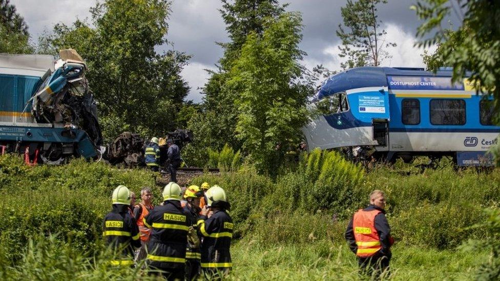 Rescuers at the scene of a train crash in village of Milavce, Czech Republic