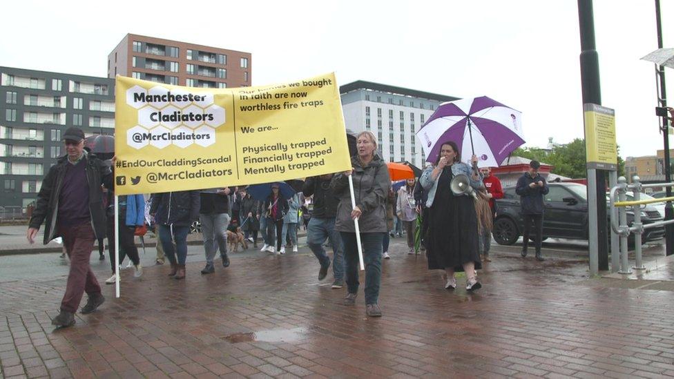 Protestors march in Salford