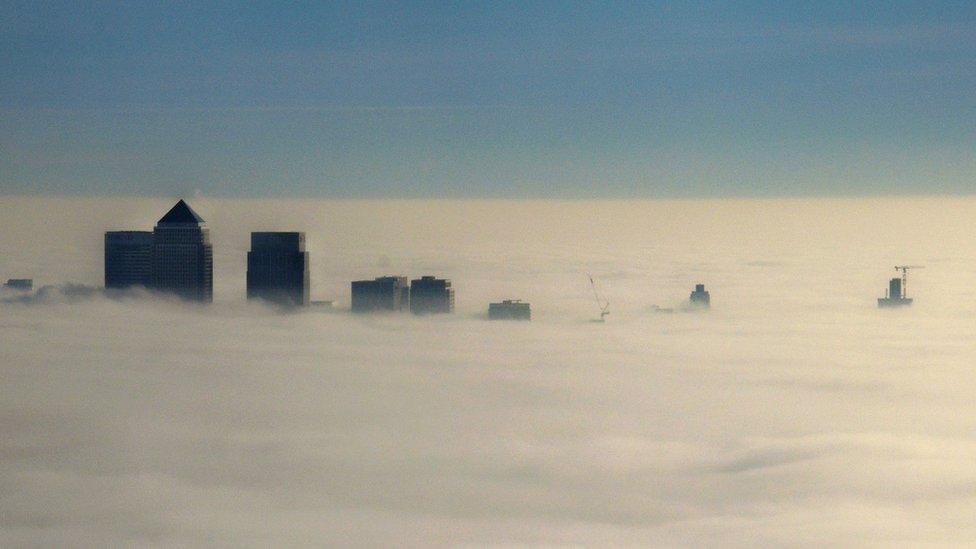 Canary Wharf peeping out of the fog