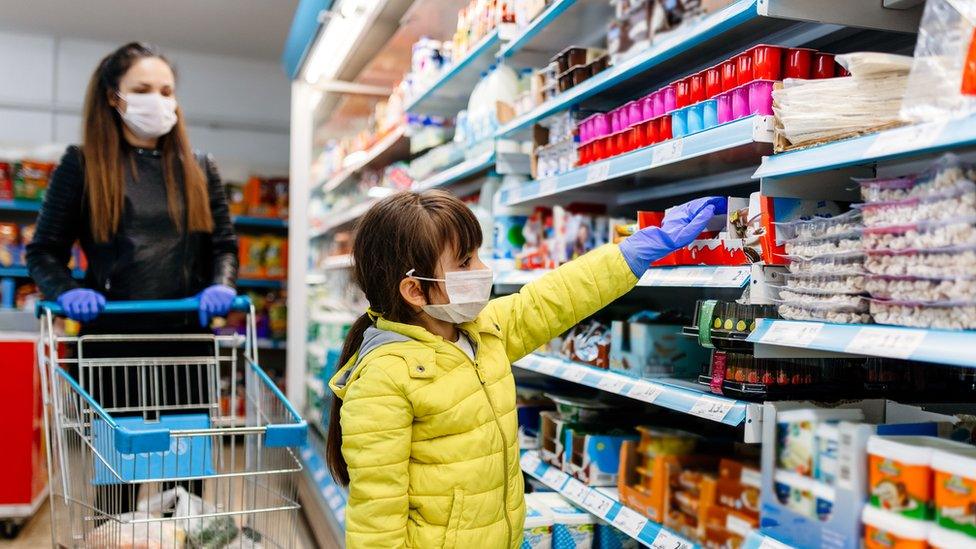 mother and child shopping in supermarket