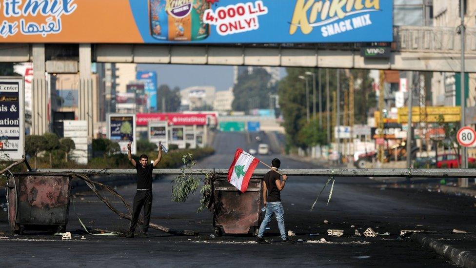 Anti-government protesters block a main road in northern Beirut, Lebanon (21 October 2019)