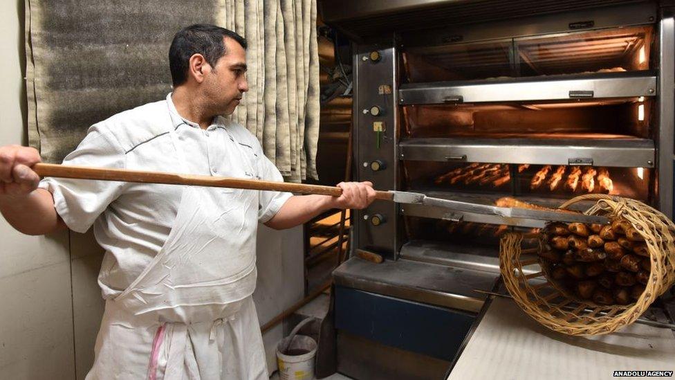 Baker making baguettes