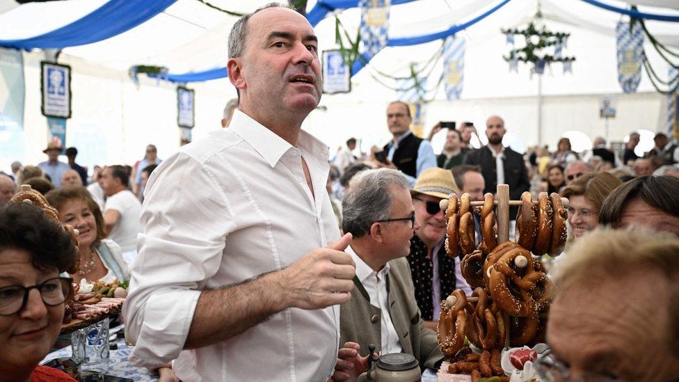 Freie Wähler leader and Bavarian Deputy Premier Hubert Aiwanger stands among spectators in a beer tent near Munich during a campaign rally