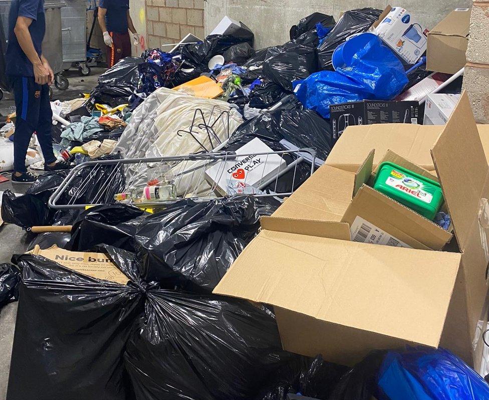 Piles of students possessions thrown into the bin stores.