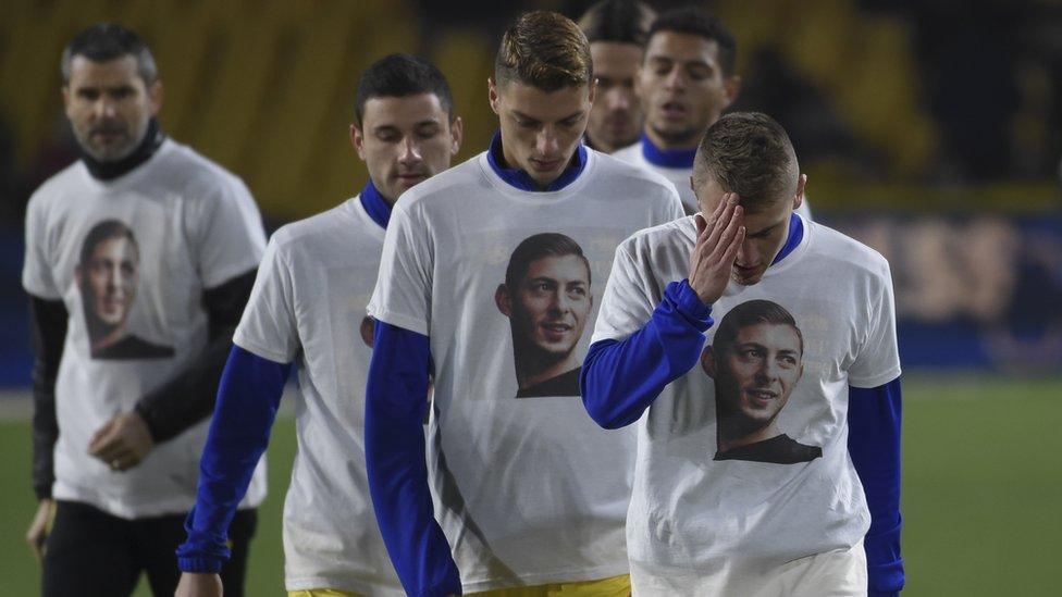 Players wearing t-shirts with Sala's face on