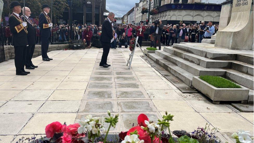 A wreath being laid at The Diamond