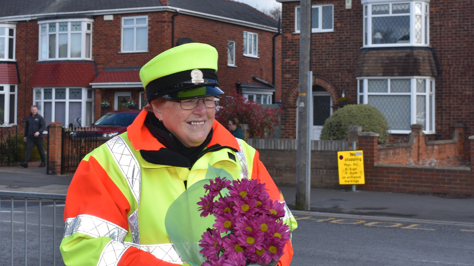 Beryl Quantrill holding a bouquet of flowers